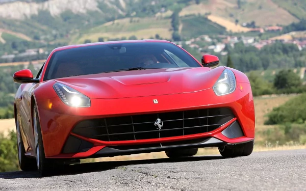 Red Ferrari F12berlinetta on a scenic road, serving as an HD desktop wallpaper.
