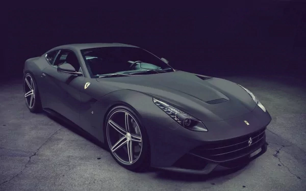 HD desktop wallpaper featuring a sleek Ferrari F12berlinetta in a dimly lit setting, showcasing its luxury design and dynamic lines.