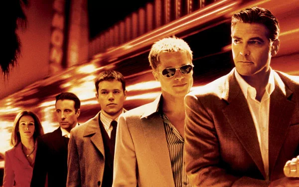 HD desktop wallpaper featuring Ocean's Eleven cast with Brad Pitt, George Clooney, Matt Damon, and Julia Roberts in a stylized group pose.