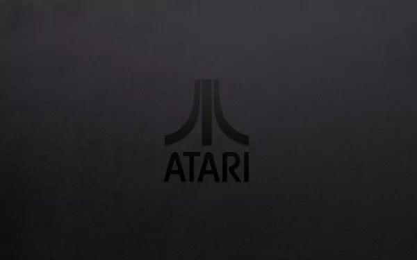 A sleek HD desktop wallpaper featuring the iconic Atari logo on a dark background, celebrating the legacy of video gaming.