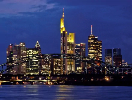 Frankfurt, Germany skyline at dusk with illuminated skyscrapers and bridge over the Main — man-made cityscape, 2K Quad HD PC desktop wallpaper.