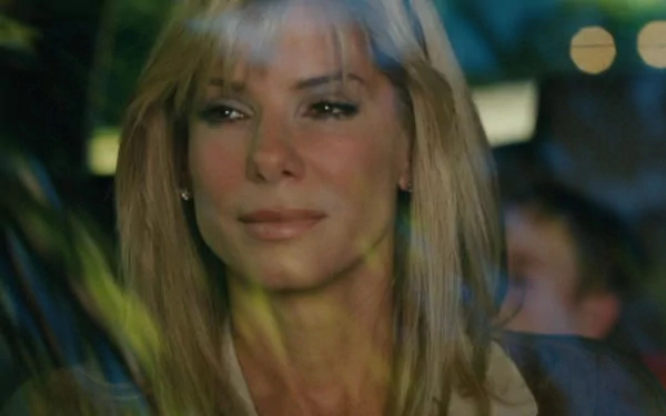 HD desktop wallpaper featuring Sandra Bullock in a scene from the movie The Blind Side, showcasing her emotional expression through a window reflection.
