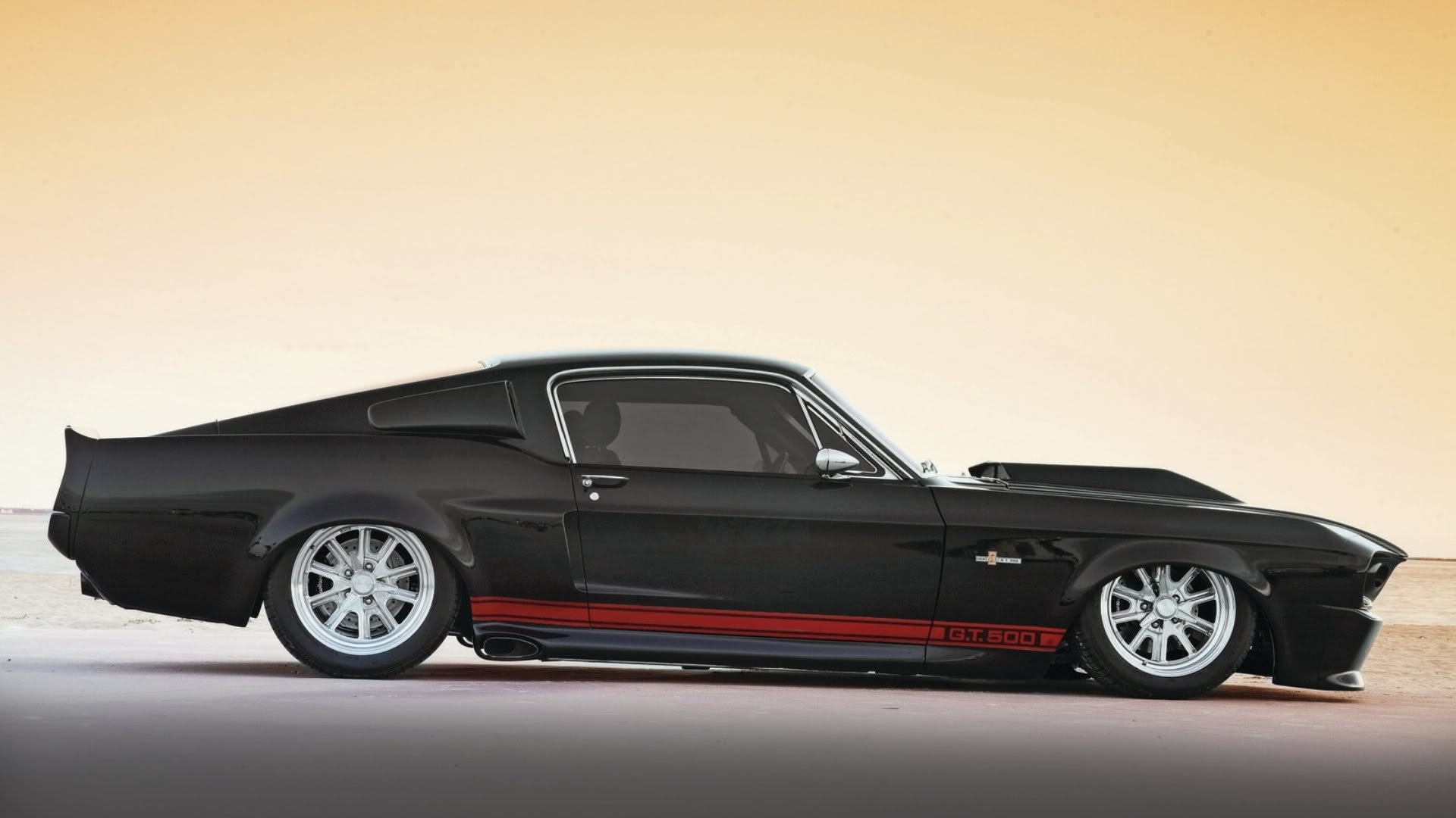 Side profile of a black Ford Mustang GT500 with white wheels and a red side stripe, HD PC desktop wallpaper.