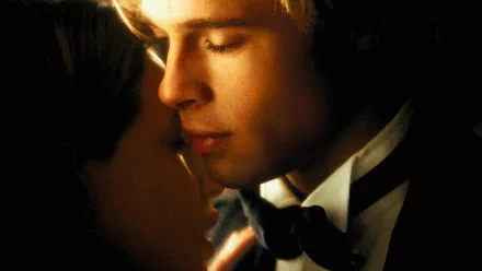 Romantic golden-lit movie still: blond man in a tuxedo and woman nearly kissing in an intimate close-up — HD PC desktop wallpaper/background.