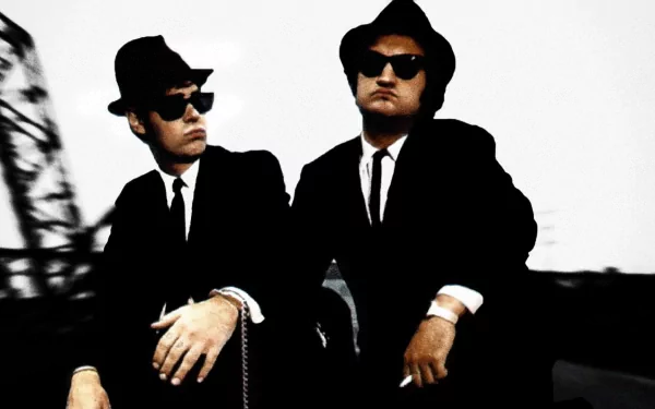 HD PC desktop wallpaper of The Blues Brothers movie, featuring the iconic characters in black suits, hats, and sunglasses against a monochrome background.