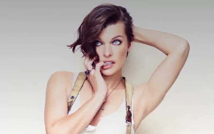 HD PC desktop wallpaper featuring celebrity Milla Jovovich with a contemplative expression against a soft gradient background.