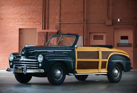 HD PC desktop wallpaper/background of a dark blue 1946 Ford Super Deluxe woody convertible vehicle parked against a brick wall.