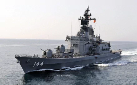 An HD image of JS Kurama (DDH-144), a Japanese Navy destroyer, sailing through the ocean, showcasing its impressive military design and capabilities.