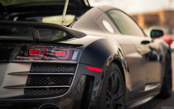 HD wallpaper featuring the rear view of an Audi R8 with a blurred background.