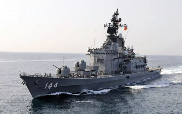 An HD image of JS Kurama (DDH-144), a Japanese Navy destroyer, sailing through the ocean, showcasing its impressive military design and capabilities.