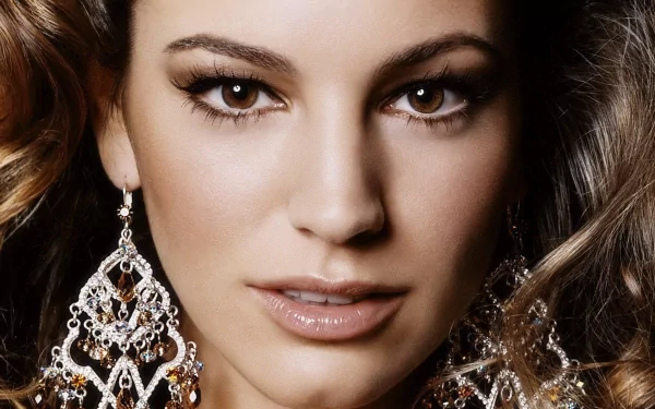 Close-up of Kelly Brook showcasing elegant earrings and captivating makeup, designed as a stunning HD desktop wallpaper and background.