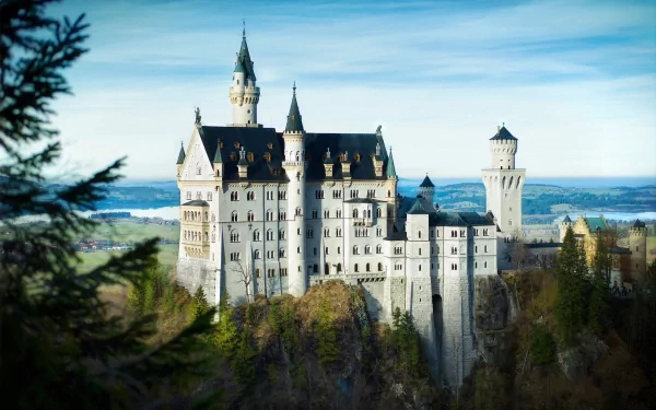 A stunning HD wallpaper of Neuschwanstein Castle, showcasing its majestic towers and intricate architecture against a serene landscape.
