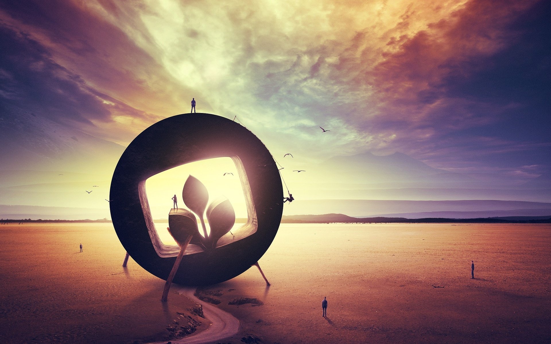 Artistic HD desktop wallpaper featuring a surreal landscape with a large circular frame, silhouetted figures, and a glowing plant against a dramatic sky.