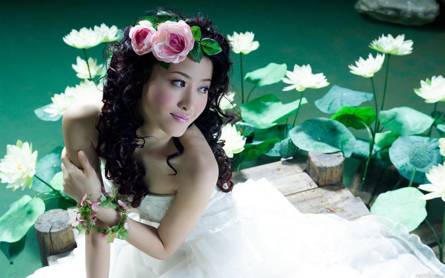 HD PC desktop wallpaper: woman, bride in a white gown with a flower crown, posed beside a green lotus pond.