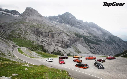 HD desktop wallpaper of a lineup of sports cars on a mountain road with Top Gear logo, suitable as a background.