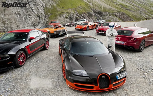 HD desktop wallpaper featuring a lineup of high-performance cars from Top Gear, with The Stig standing amid them on a mountain road.