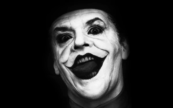 Black and white HD desktop wallpaper of Jack Nicholson as the Joker, featuring a close-up of his iconic eerie grin and makeup.