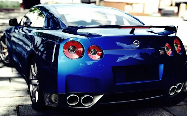 A stunning HD desktop wallpaper featuring a blue Nissan GT-R, showcasing its sleek design and powerful stance from a rear perspective.