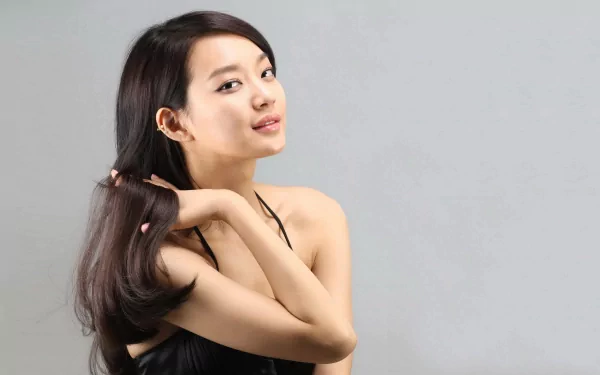HD PC desktop wallpaper featuring a woman, Shin Min Ah, with long dark hair posing against a plain gray background.