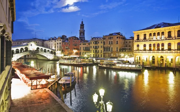 HD PC desktop wallpaper: Venice, Italy at dusk — Rialto Bridge and canals with illuminated historic man-made architecture reflected in the water.