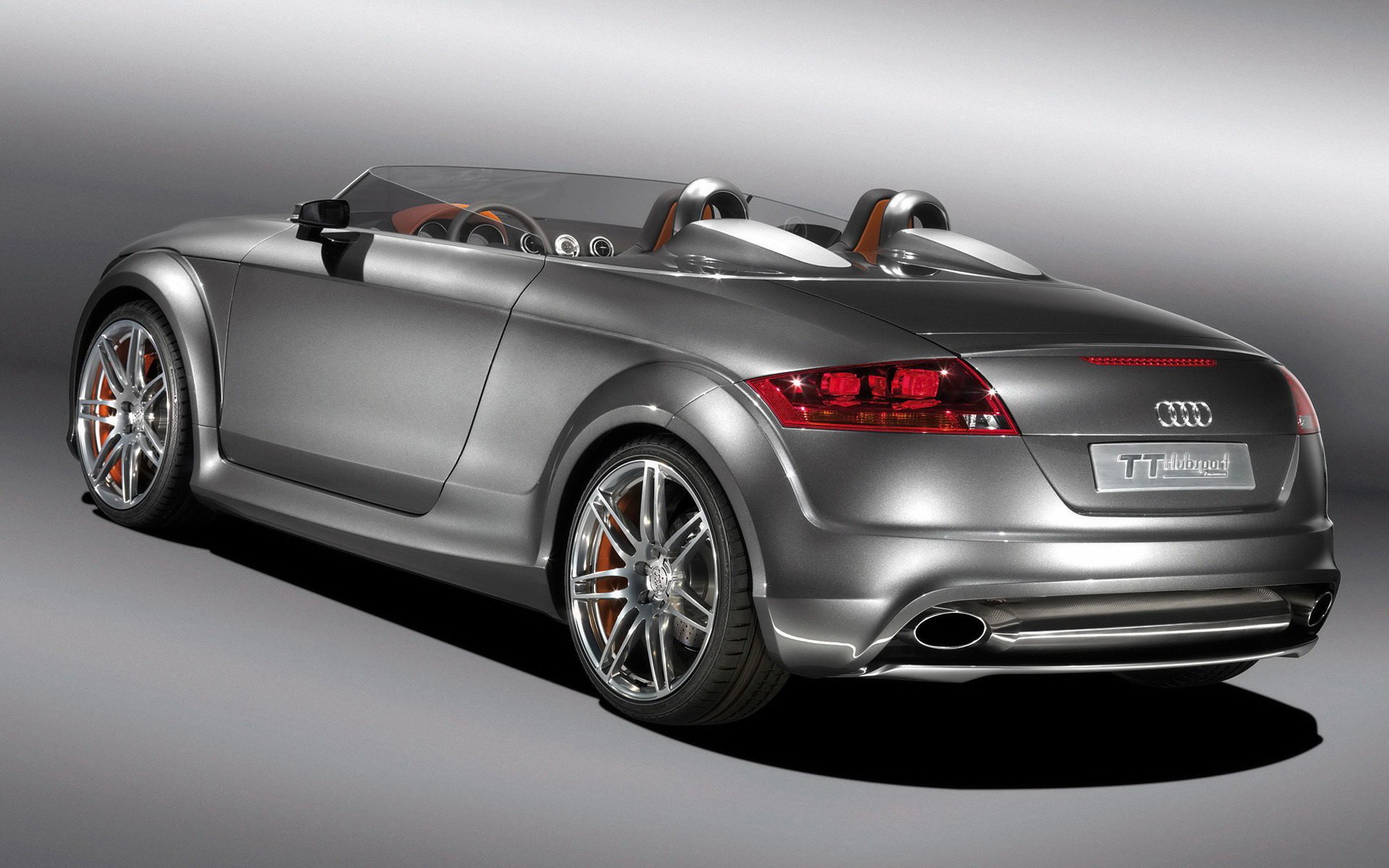 Silver Audi TT convertible, rear three-quarter studio shot with polished alloy wheels — HD PC desktop wallpaper and background.