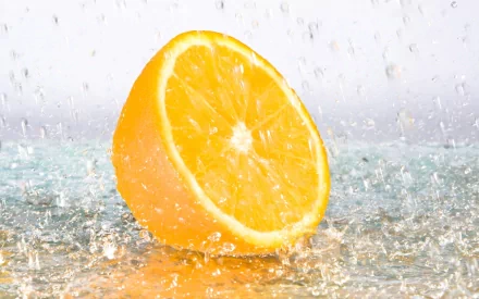 HD PC desktop wallpaper featuring a vibrant orange slice with water droplets, highlighting the bright orange color and fresh, juicy texture of the fruit.