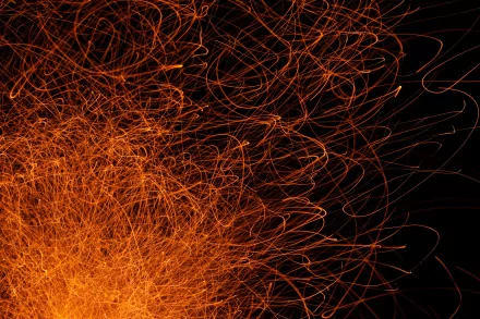 Abstract HD PC desktop wallpaper featuring dynamic, tangled orange lines on a black background, creating an energetic and chaotic visual effect.