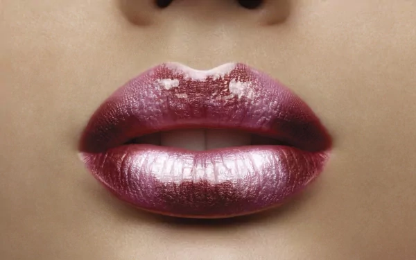 Close-up of glistening lips, showcasing a soft, glossy finish. This HD image serves as an attractive desktop wallpaper and background.