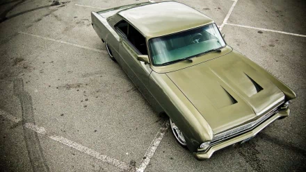 HD PC desktop wallpaper of an olive-green 1966 Chevrolet Nova, parked at an angle on cracked asphalt in a parking lot.