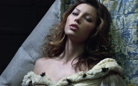 Jessica Biel poses elegantly in this HD desktop wallpaper, showcasing her stunning features against a softly lit background.
