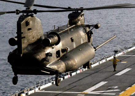 Military Boeing CH-47 Chinook helicopter landing on a ship deck, captured in high definition for a striking PC desktop wallpaper.