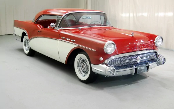 HD desktop wallpaper featuring a classic red and white 1957 Buick Century parked indoors, showcasing its vintage design and chrome details.