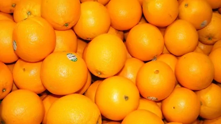 HD close-up image of vibrant orange fruits, highlighting their bright color and texture, designed as a vivid desktop wallpaper and background.