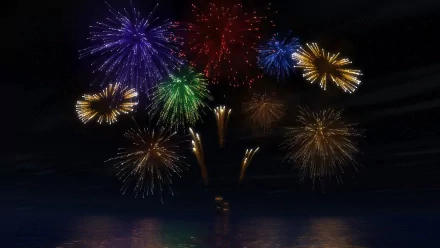 Photography: vibrant multicolored fireworks burst over dark water at night, reflections below — HD PC desktop wallpaper and background.