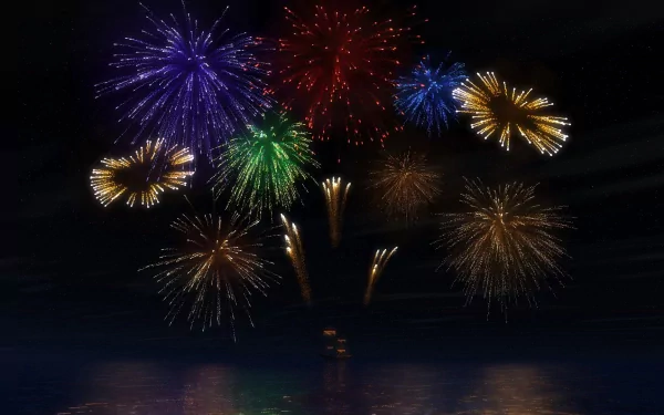 Photography: vibrant multicolored fireworks burst over dark water at night, reflections below — HD PC desktop wallpaper and background.