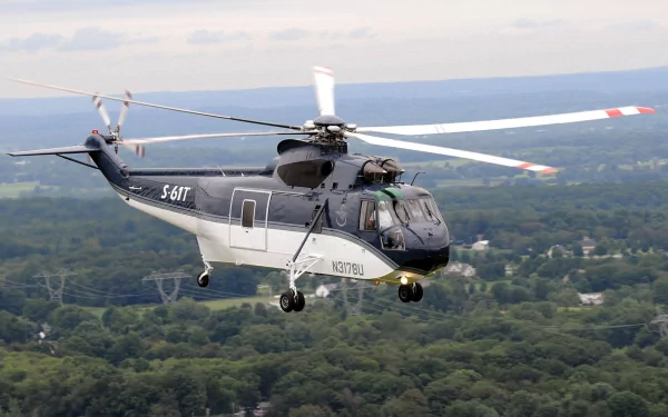 HD PC desktop wallpaper of a Sikorsky S-61T helicopter — Sikorsky S vehicle — flying over a wooded landscape.