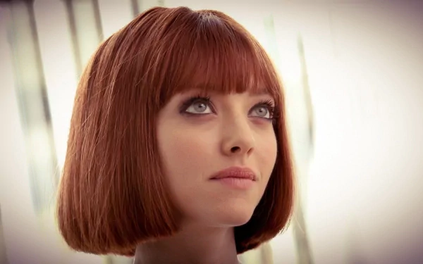 HD desktop wallpaper featuring celebrity Amanda Seyfried with a striking red bob haircut and soft, natural lighting.