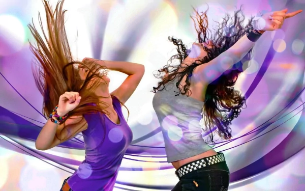 HD desktop wallpaper featuring two women dancing with vibrant flowing hair, set against a colorful, swirling abstract background. Tags: music, dance.