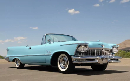 Sky-blue 1957 Chrysler Imperial convertible on a sunlit desert road, photographed as an HD PC desktop wallpaper.