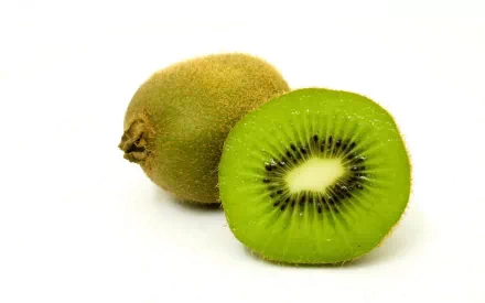 HD desktop wallpaper featuring a close-up of a whole kiwi and a half kiwi with vibrant green flesh and seeds, highlighting fresh food in vivid detail.
