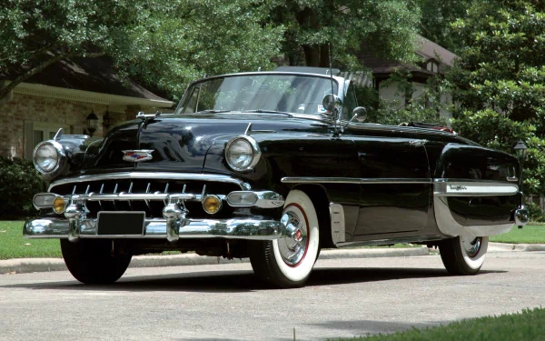 A polished black 1954 Chevrolet Bel Air convertible parked on a driveway, captured in HD for a desktop wallpaper and background.