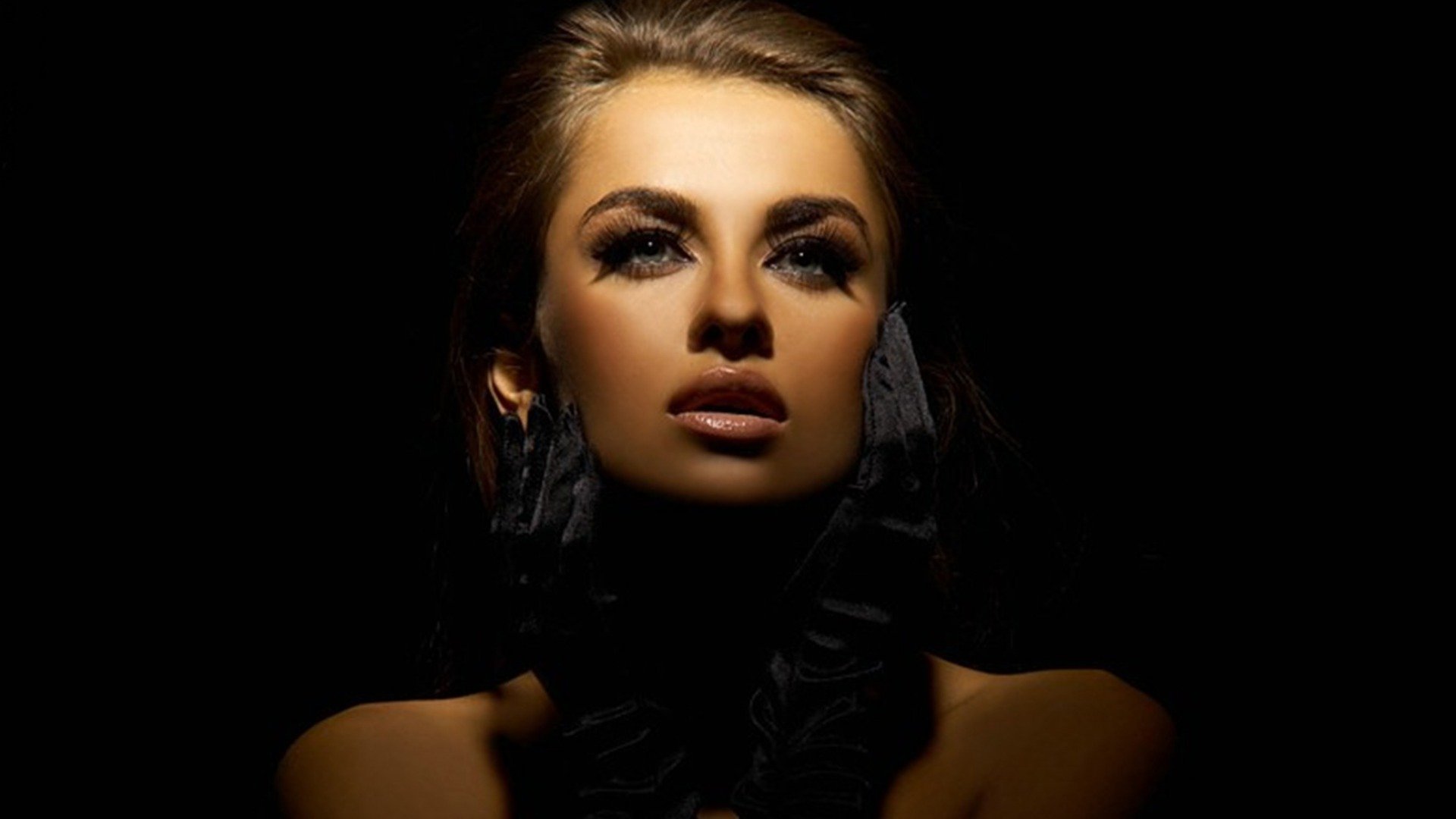 HD PC desktop wallpaper featuring a dramatic portrait of woman Natalia Siwiec illuminated against a dark background.