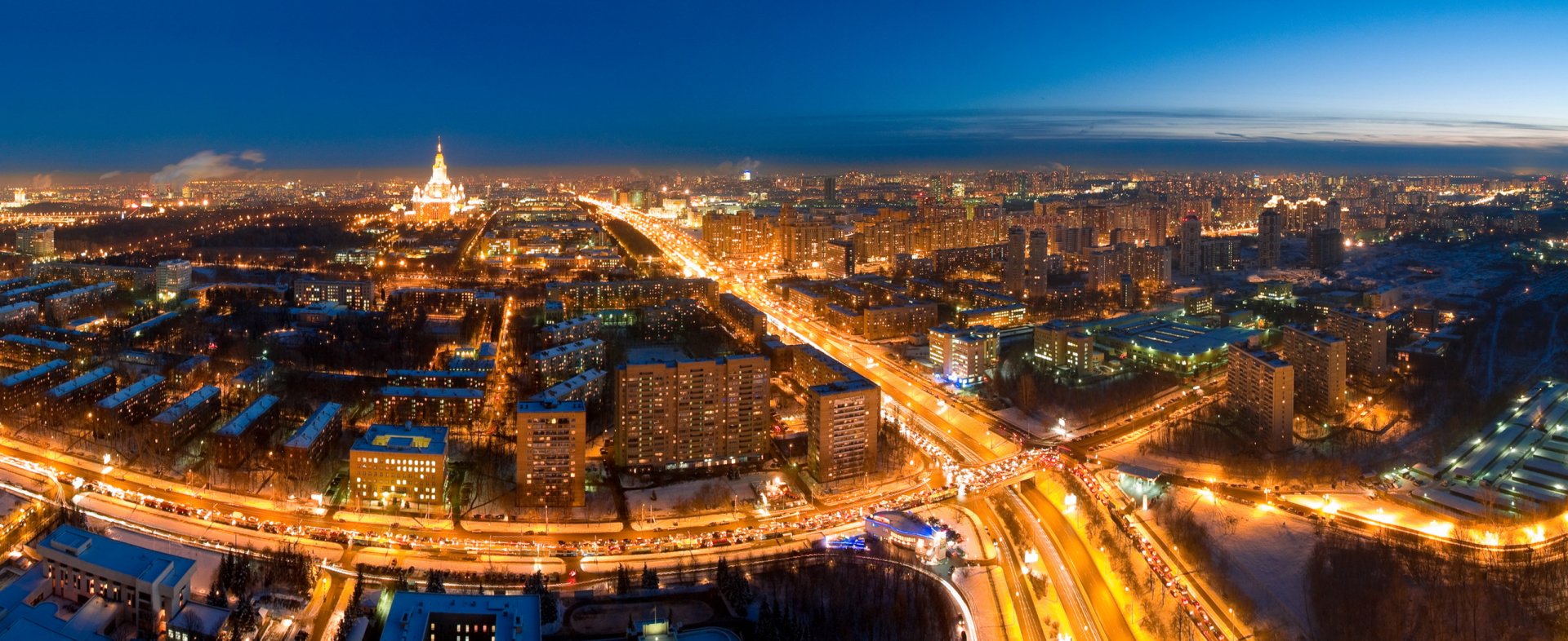 Nighttime aerial view of Moscow, Russia, showcasing illuminated city streets and buildings in this HD man-made urban landscape wallpaper.