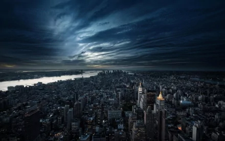 A stunning nighttime view of Manhattan, showcasing the city's skyline under a dramatic sky. The image captures the vibrant energy of New York City in high definition.