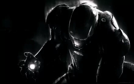 HD PC desktop wallpaper featuring a dark, dramatic silhouette of Iron Man from the Tony Stark movie series, highlighting the glowing arc reactor on his hand.