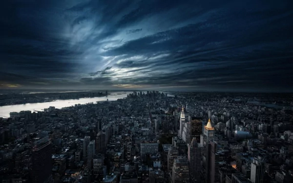 A stunning nighttime view of Manhattan, showcasing the city's skyline under a dramatic sky. The image captures the vibrant energy of New York City in high definition.