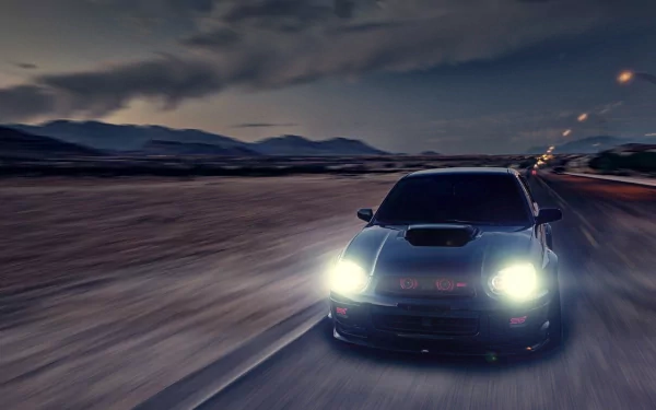 HD PC desktop wallpaper: front-facing Subaru Impreza racing down a desolate highway at dusk, bright headlights cutting through a motion-blurred landscape.
