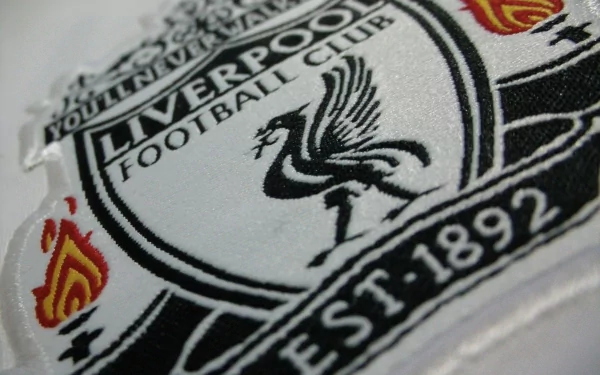 Detailed close-up of the Liverpool F.C. crest, showcasing the iconic Liver bird and flames, designed as an HD desktop wallpaper for sports enthusiasts.