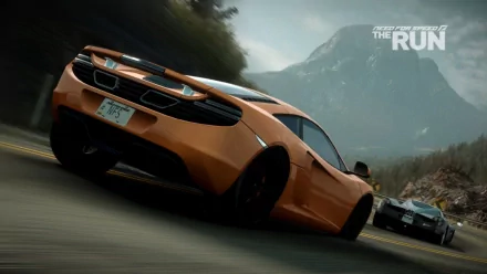 HD PC desktop wallpaper featuring a high-speed orange sports car racing on a mountain road from the video game Need For Speed: The Run.