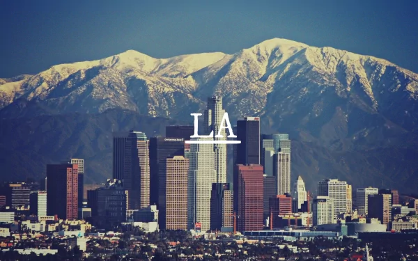 A stunning HD desktop wallpaper showcasing the Los Angeles skyline with snowy mountains in the background, capturing the vibrant essence of the city.